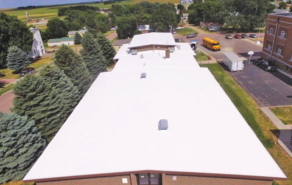 Aerial view of the finished white silicone restoration on the Colome Elementary School roof in Colome, South Dakota
