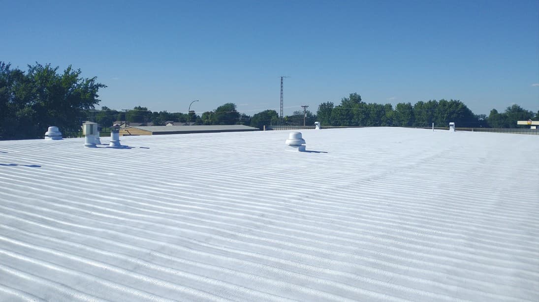 The seamless coated spray foam roof field across Freeman Shopping Center