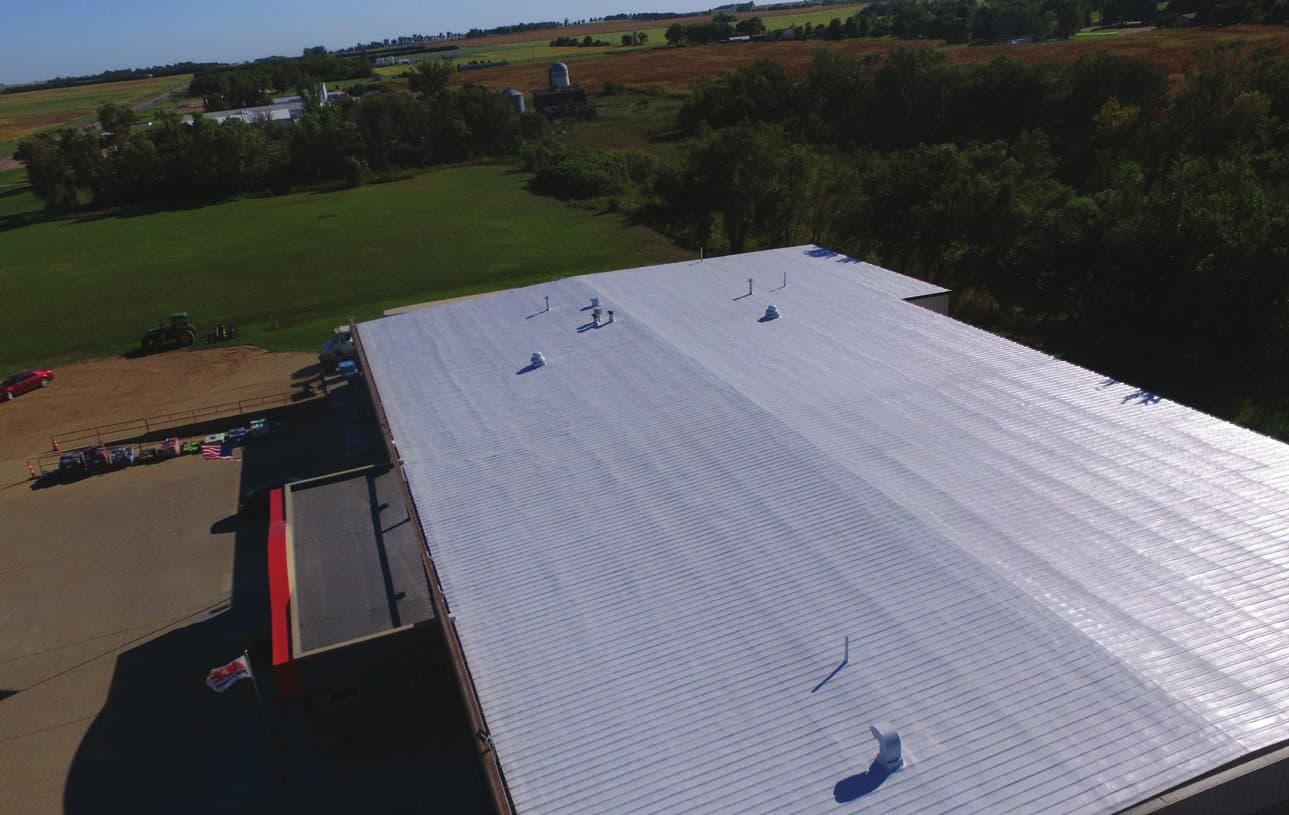 Aerial view of the completed spray polyurethane foam and acrylic coated roof on Freeman Shopping Center in Freeman, South Dakota