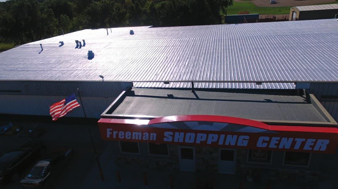 The completed SPF and acrylic roof above the Freeman Shopping Center storefront signage
