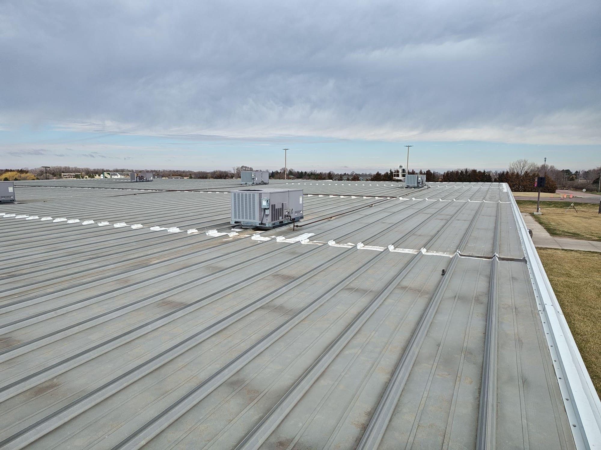 Standing-seam metal roof on the Was Ake' Building in Wagner, South Dakota, before A-1's coating restoration