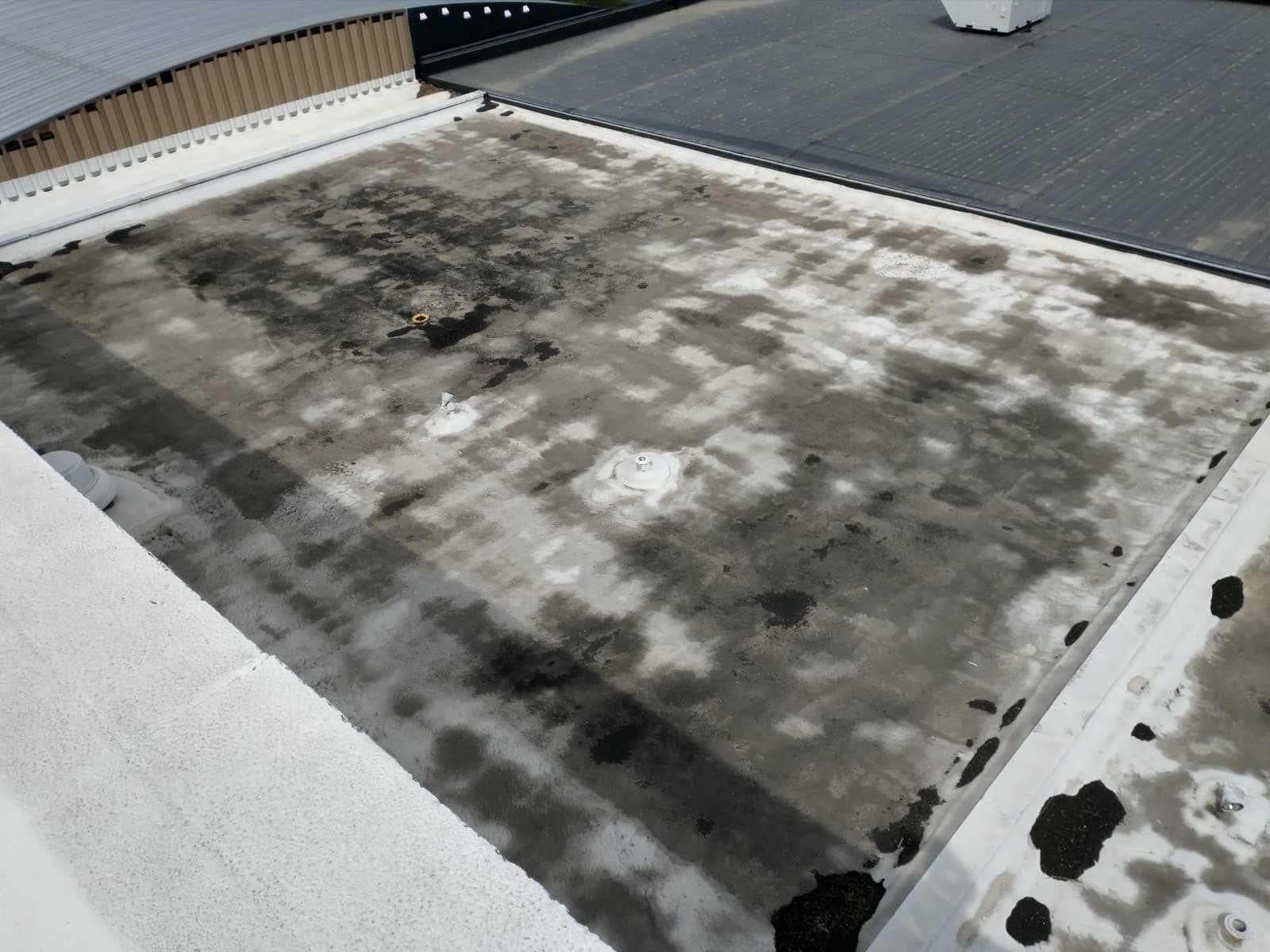 Saturated and patched spray foam roof at the Woonsocket school before A-1's restoration